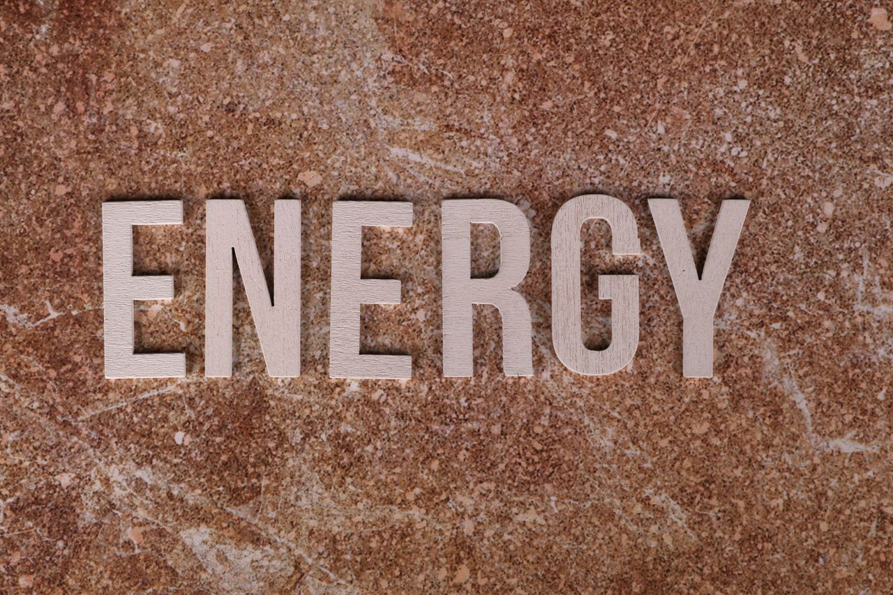 Word Energy on natural stone texture, symbolizing raw power.